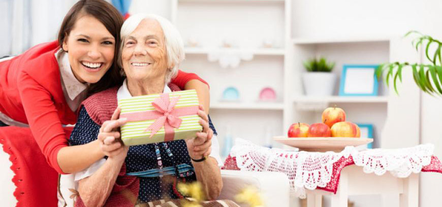 Two women holding a present