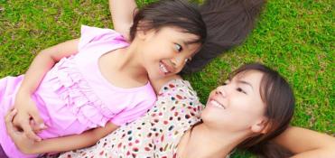 Mother and daughter in the grass