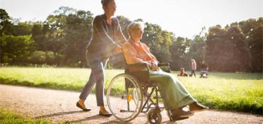 Woman pushing a wheelchiar