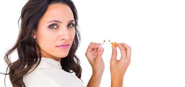 Woman snapping a cigarette in two